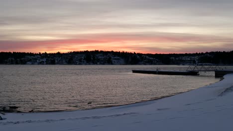 snowy-landscape-at-the-end-of-the-day-near-a-lake