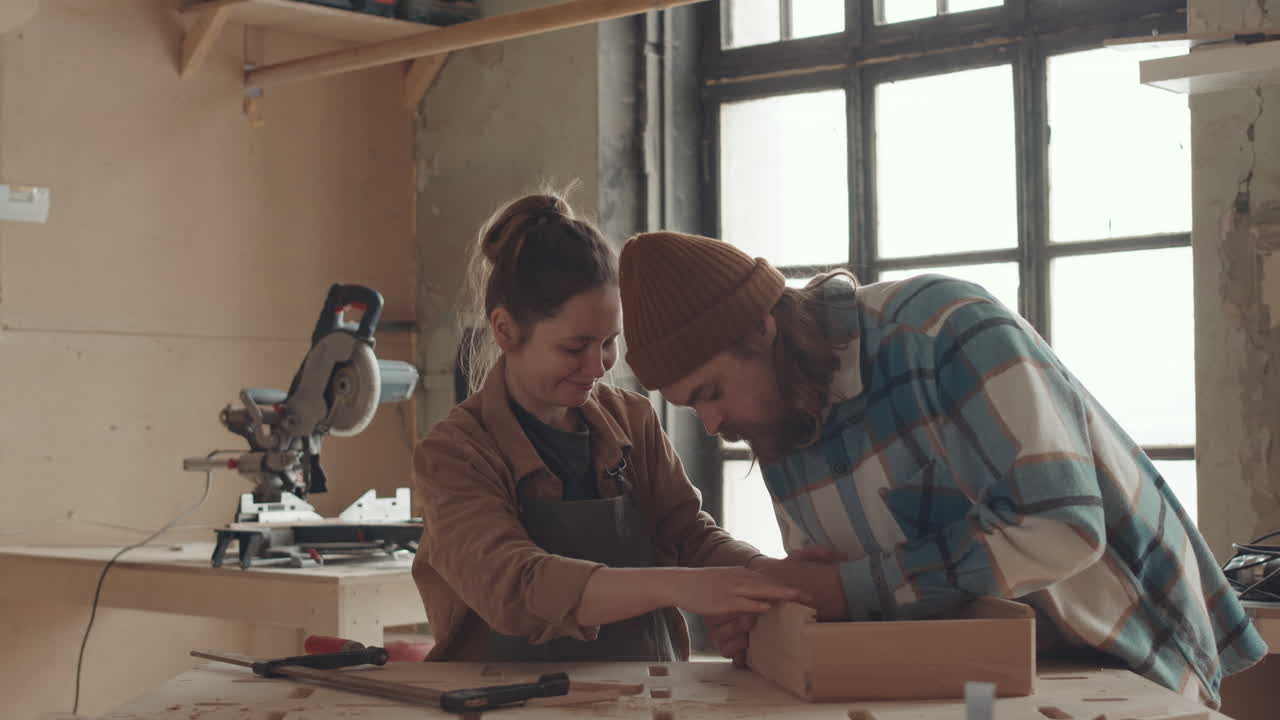 Two Joiners Making Wooden Box in Carpentry Workshop