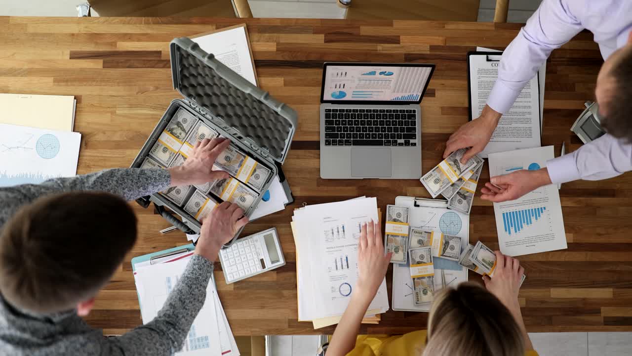 Business meeting with money and data analysis