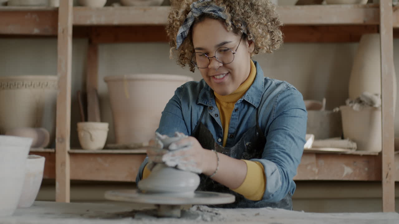 Woman Potter Shaping Clay on a Pottery Wheel