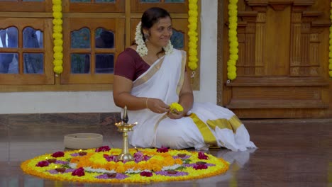 athapookkalam decorating for onam festival in kerala ,pookalam decorating kerala traditional family for onam celebration