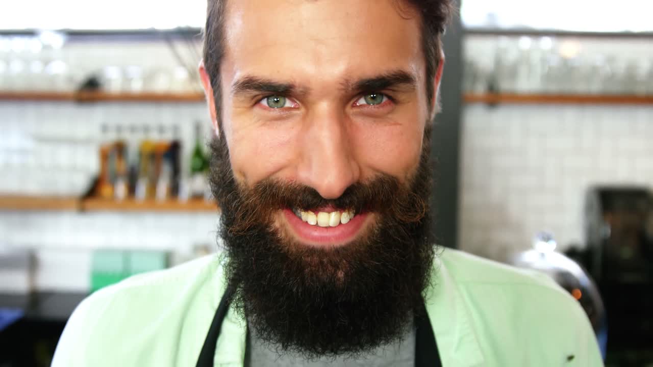 retrato de un camarero de pie con un cartel abierto
