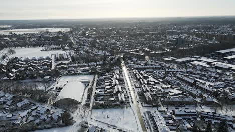 aerial of a beautiful snow covered town on a overcast day