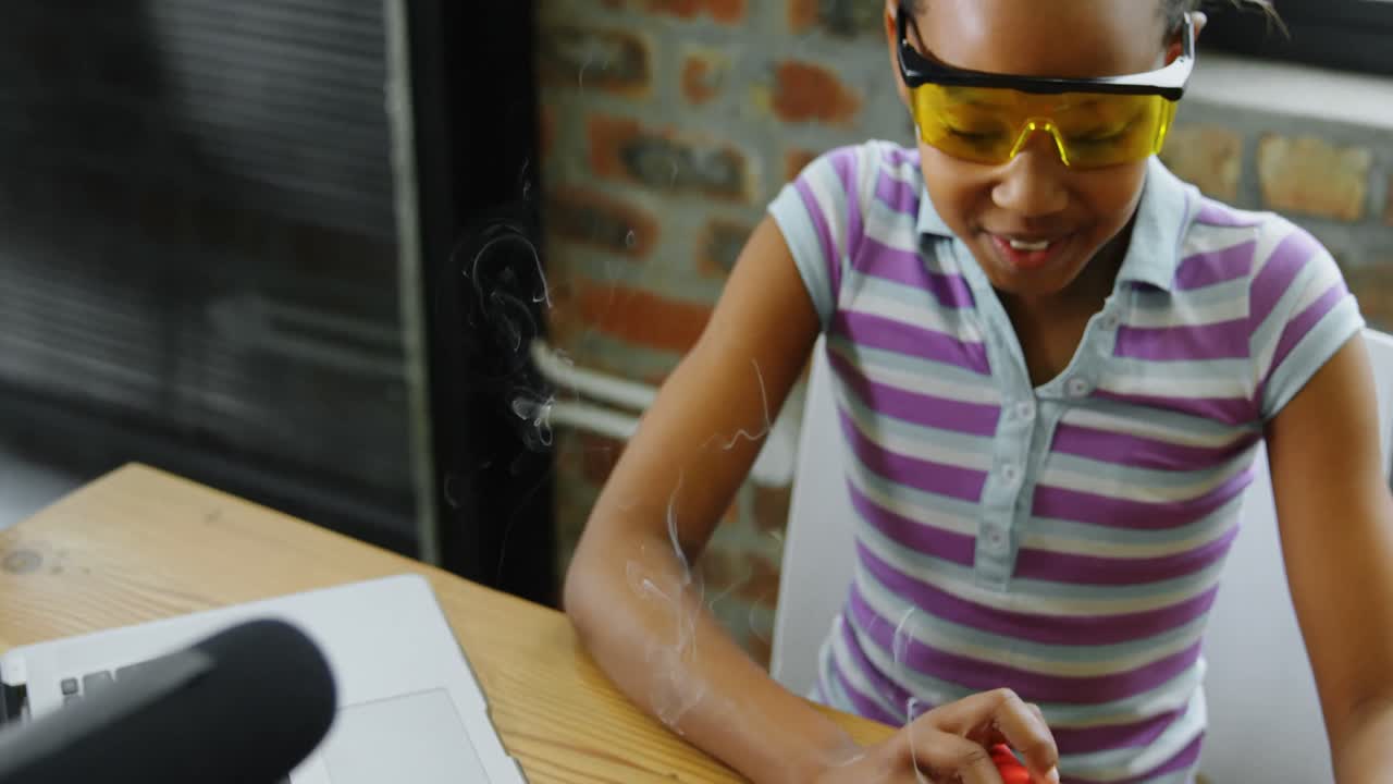 Teenage blogger soldering a circuit board 4k