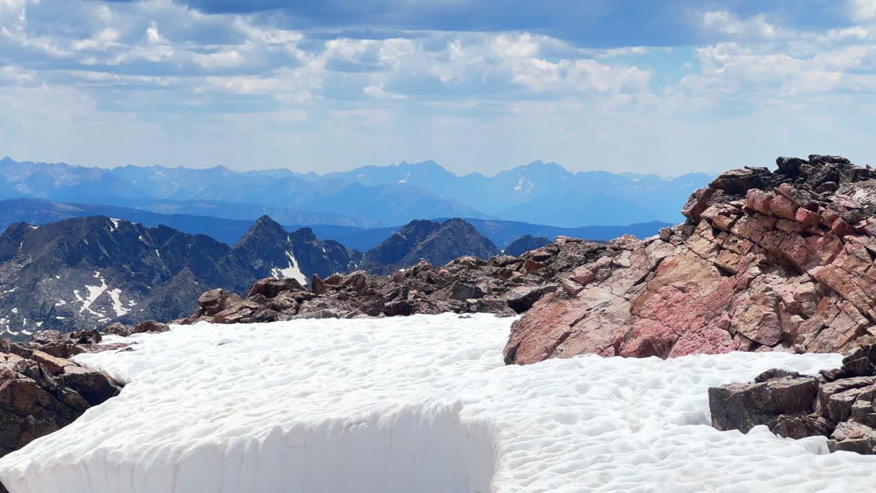 Maroon Bells Pyramid Peak Aspen Snowmass Elk Mountains Range view from Mount of the Holy Cross 14er snow field summer afternoon Rocky Mountain Colorado Halo Ridge trail catwalk cornice avalanche chute