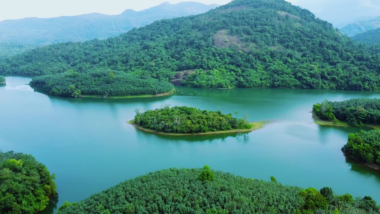Aerial View of a Serene Lake Surrounded by Lush Green Mountains and Forests