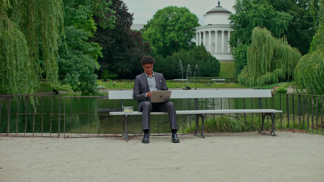Man working on a laptop in a park