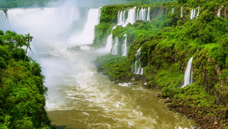 Timelapse-of-Waterfalls-of-Iguazu-around-a-big-green-area-and-a-river,-in-a-sunny-day,-Foz-do-Iguacu,-Parana,-Brazil