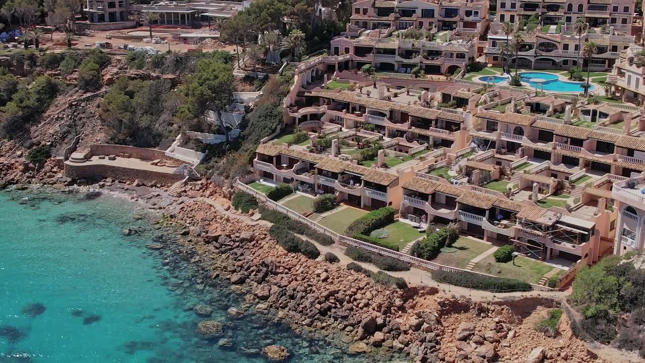 Aerial view of coastal homes along the shore in Mallorca, Spain
