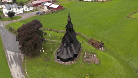 black wooden stave christian church in countryside of norway