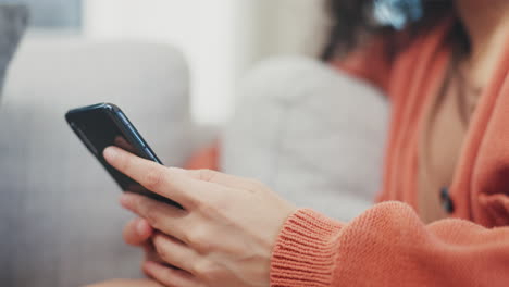 Hands,-woman-and-typing-on-smartphone-in-lounge