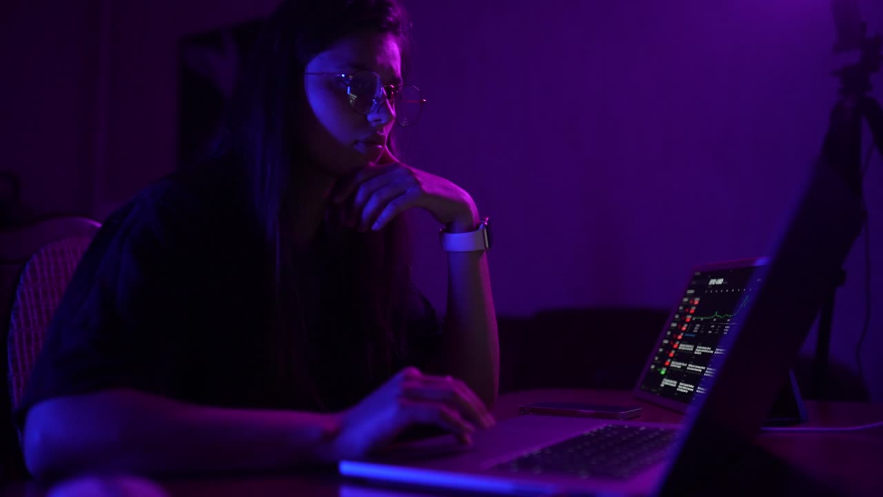 Young Woman Working on Laptop at Night