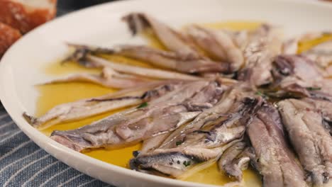 fresh sea sardines and anchovy fish and mullus on display on ice on market store shop. seafood fish background, close up stand of small salty white fish.