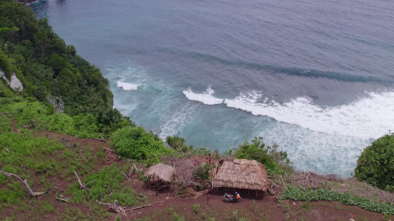 Small local hut at edge of high cliff Sumba island, aerial shot