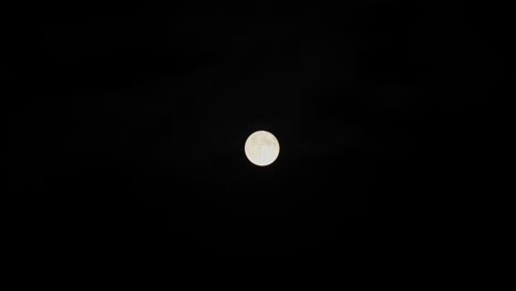 stunning 4k video of a full moon filmed at night with telephoto lens.