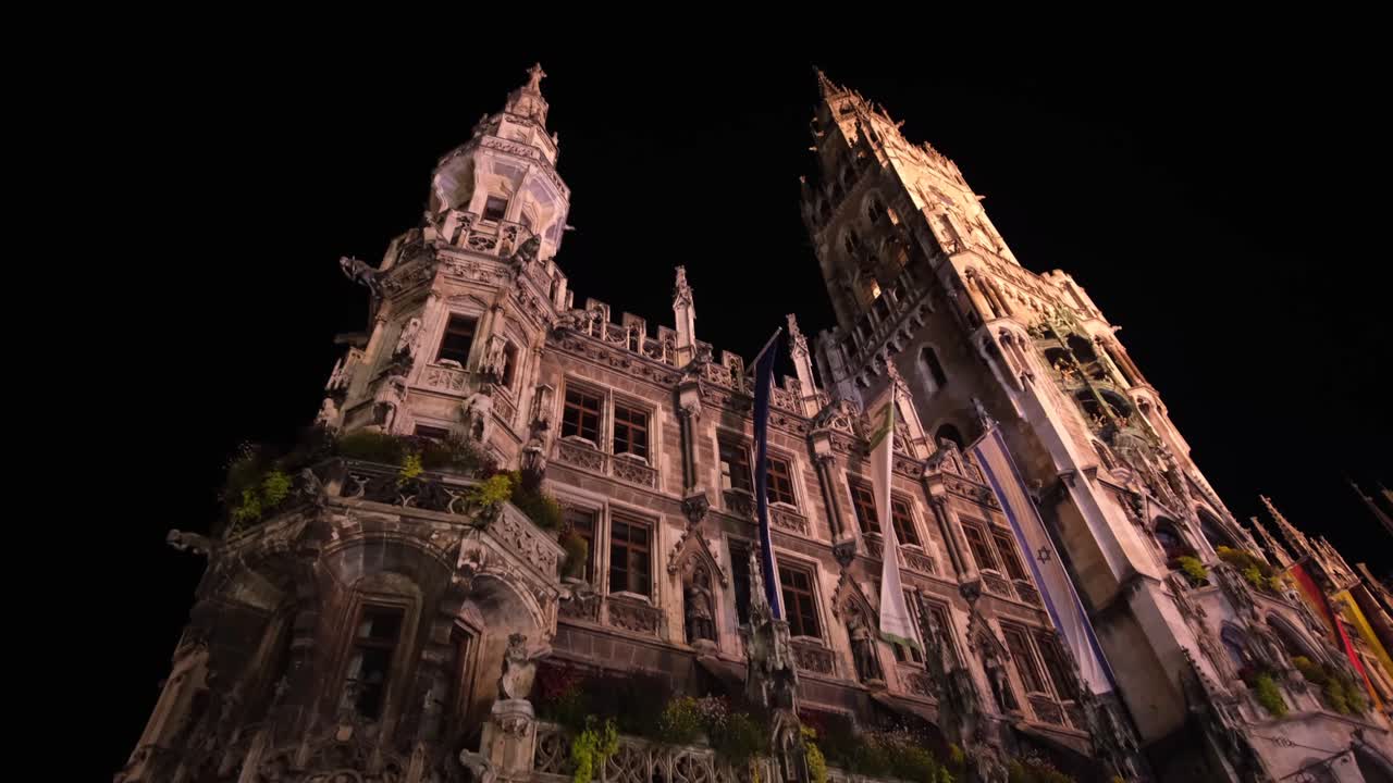 The Munich Municipal Building stands illuminated at night, showcasing its stunning architectural design and captivating structure.