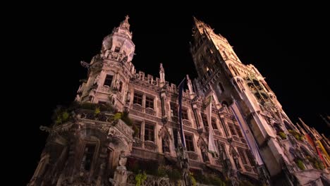 the munich municipal building stands illuminated at night, showcasing its stunning architectural design and captivating structure.