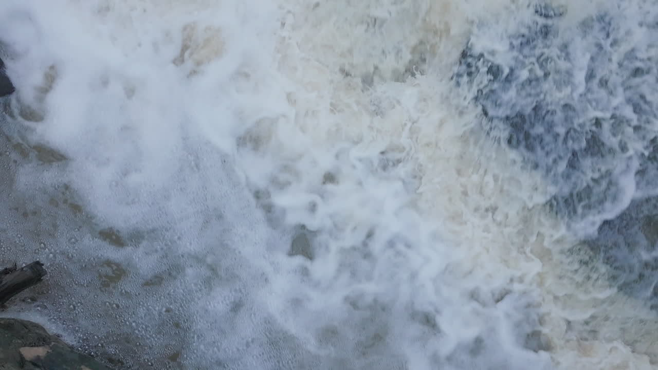 Rushing water over rocks, captured from above, creating foamy white waves near Rockway Falls, Ontario