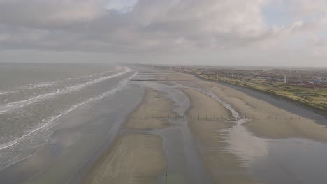 vast beach, ocean and township buildings, aerial panoramic view