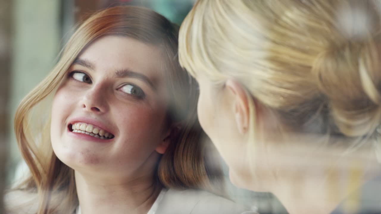 카페에서 커피를 마시는 디지털 태블릿을 사용하는 두 명의 여성