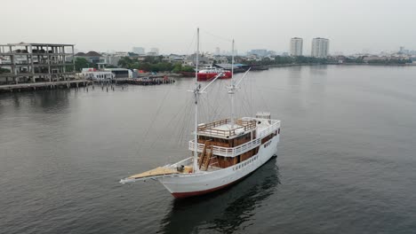 white sailing yacht in a city river