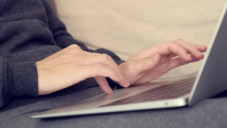 female hands and fingers above notebook touch pad close-up 4k video