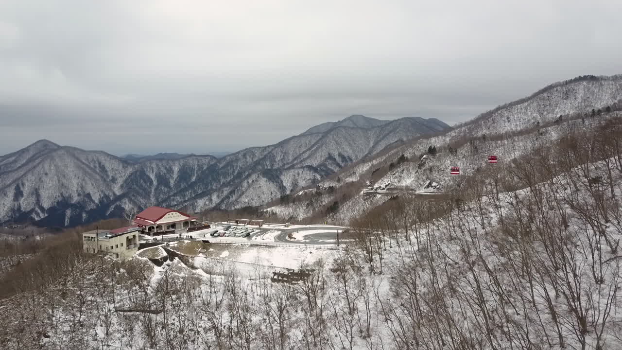 Snow covered Akechidaira Ropeway Observation Deck in the middle of winter, aerial dolly