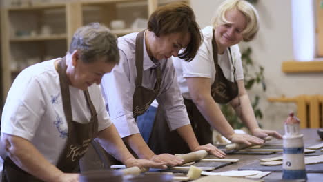 women learning pottery in a workshop