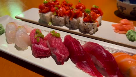 beautiful selection of traditional sushi in a japanese restaurant, spicy tuna roll and wasabi, raw fish on rice, 4k shot