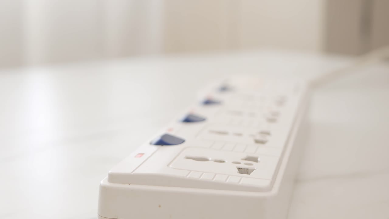 Close up Male hand unplugs in a power cord on the table