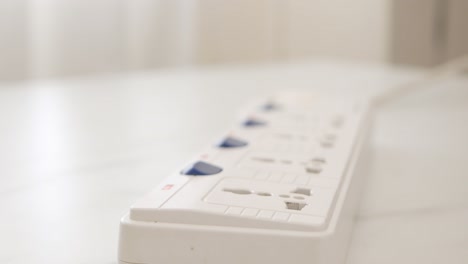 Close-up-Male-hand-unplugs-in-a-power-cord-on-the-table