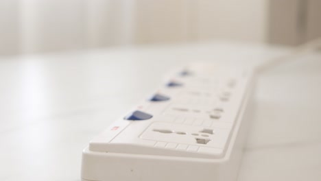 cerrar la mano masculina se desconecta en un cable de alimentación en la mesa