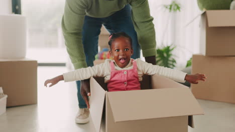 Child,-father-and-pushing-box-in-new-house