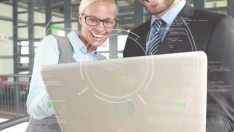 Two business colleagues are using a laptop and talking