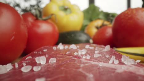 zoom out macro video of sea salt on raw steak