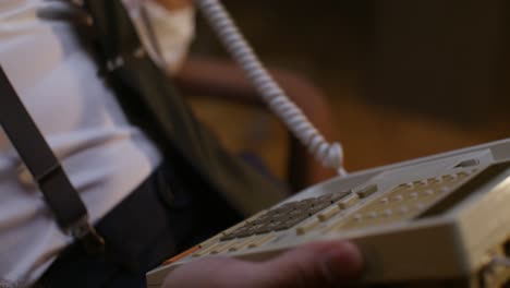 person using an old rotary dial telephone