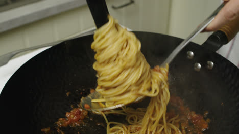 Taking-out-pasta-bolognese-from-cooking-pan