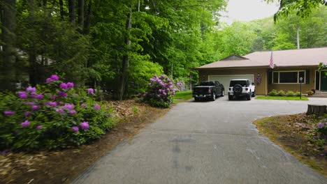 pushing toward a home in summer with blooming rhododendrons