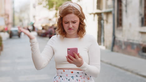 young woman use smartphone loses bad news fortune loss fail fail virus thief fraud in city street