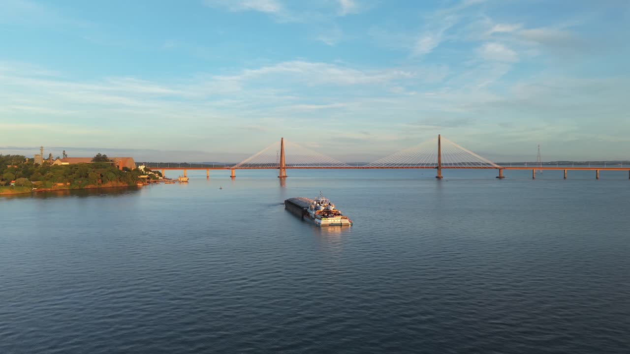 Drone view of cargo barge navigating on Parana River, logistics infrastructure