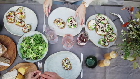 Two-people-eating-delicious-breakfast---table-top-shot