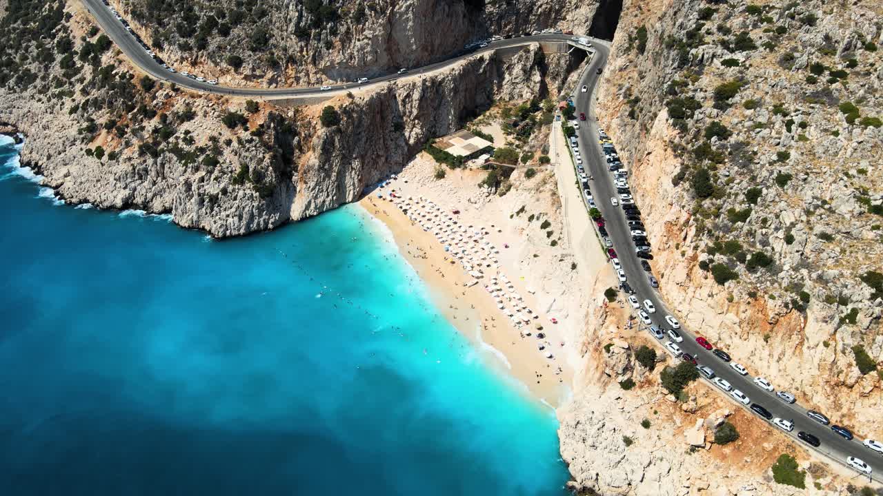 Flying drone close-up over the water surface of the mountain serpentine small beach hidden at the foot of the mountains