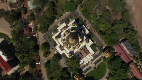 top down rotating aerial view of buu long pagoda, a beautiful buddhist temple with large gold roof structure in saigon, ho chi minh city, vietnam on a sunny clear day