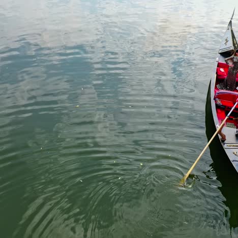 Beautiful woman riding in gondola. Luxury woman travels in a boat along the river in Venice, Italy. Aerial view.