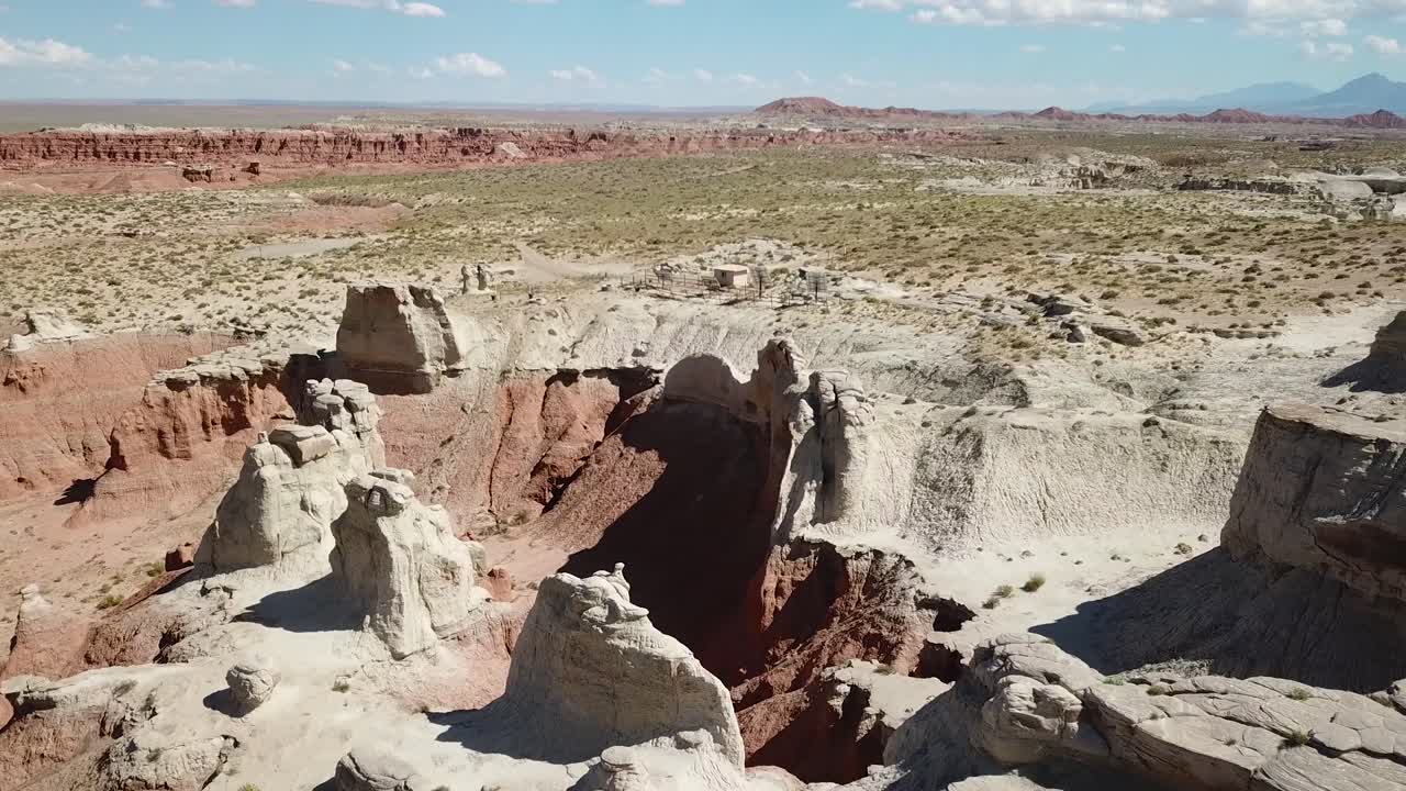 Arid Desert Landscape with Rock Formations and Canyon