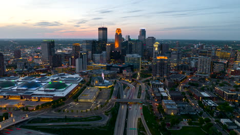 Aerial-hyperlapse-view-of-Minneapolis-CBD-skyline-illuminating-at-twilight