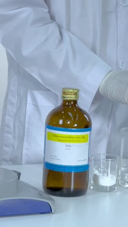 chemist demonstrates iodine clock reaction experiment