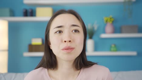 Close-up-portrait-of-young-Asian-woman-looking-around-with-fear.