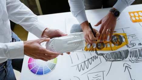 car designers working at desk in office 4k