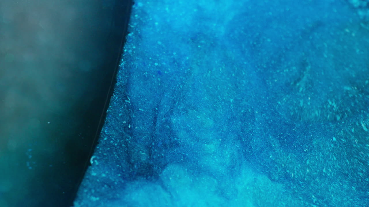 Ink in motion creating sea water abstract form. Macro